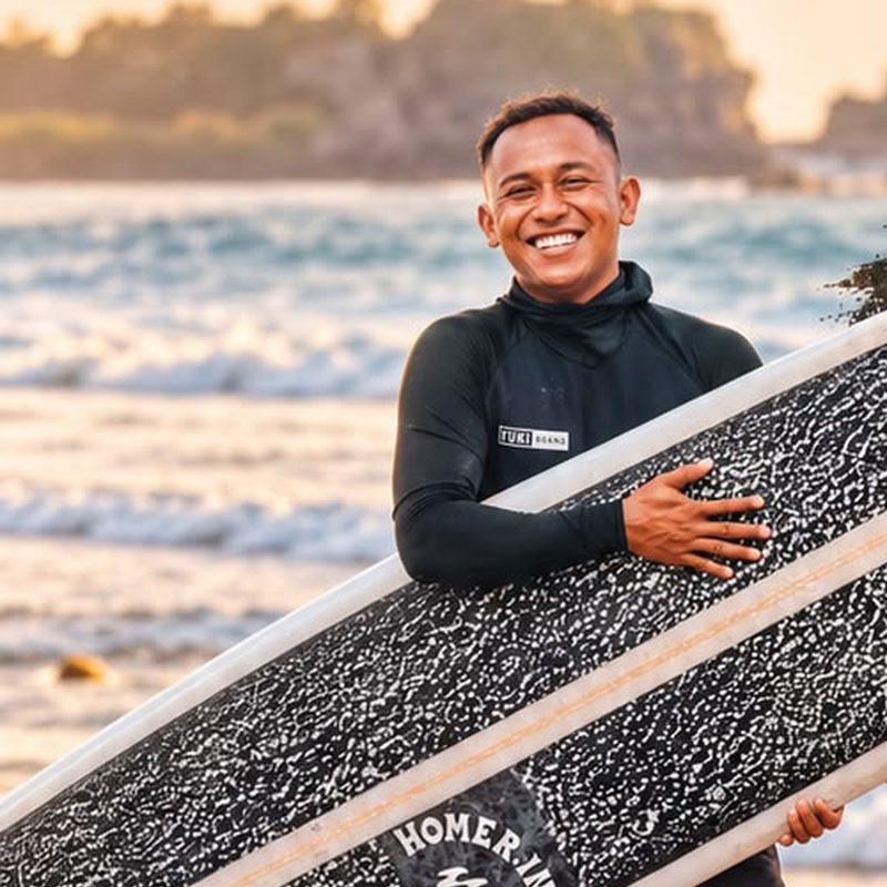 Black Surf Bali coach with a longboard on Sanur beach